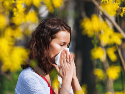 Women sneezing into tissue